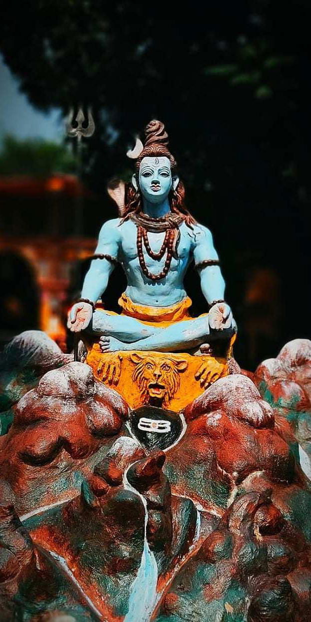 Meditating Shiva amongst mountain rocks