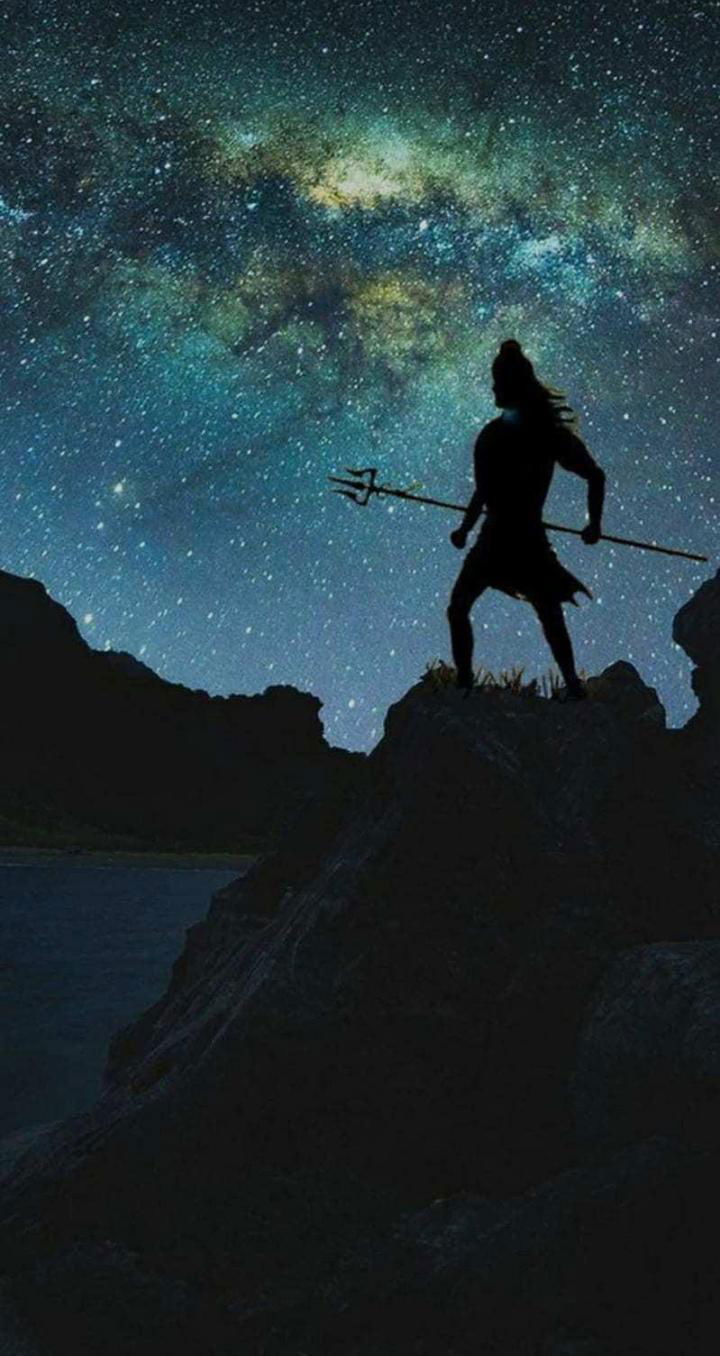 Shiva silhouette against starry night sky