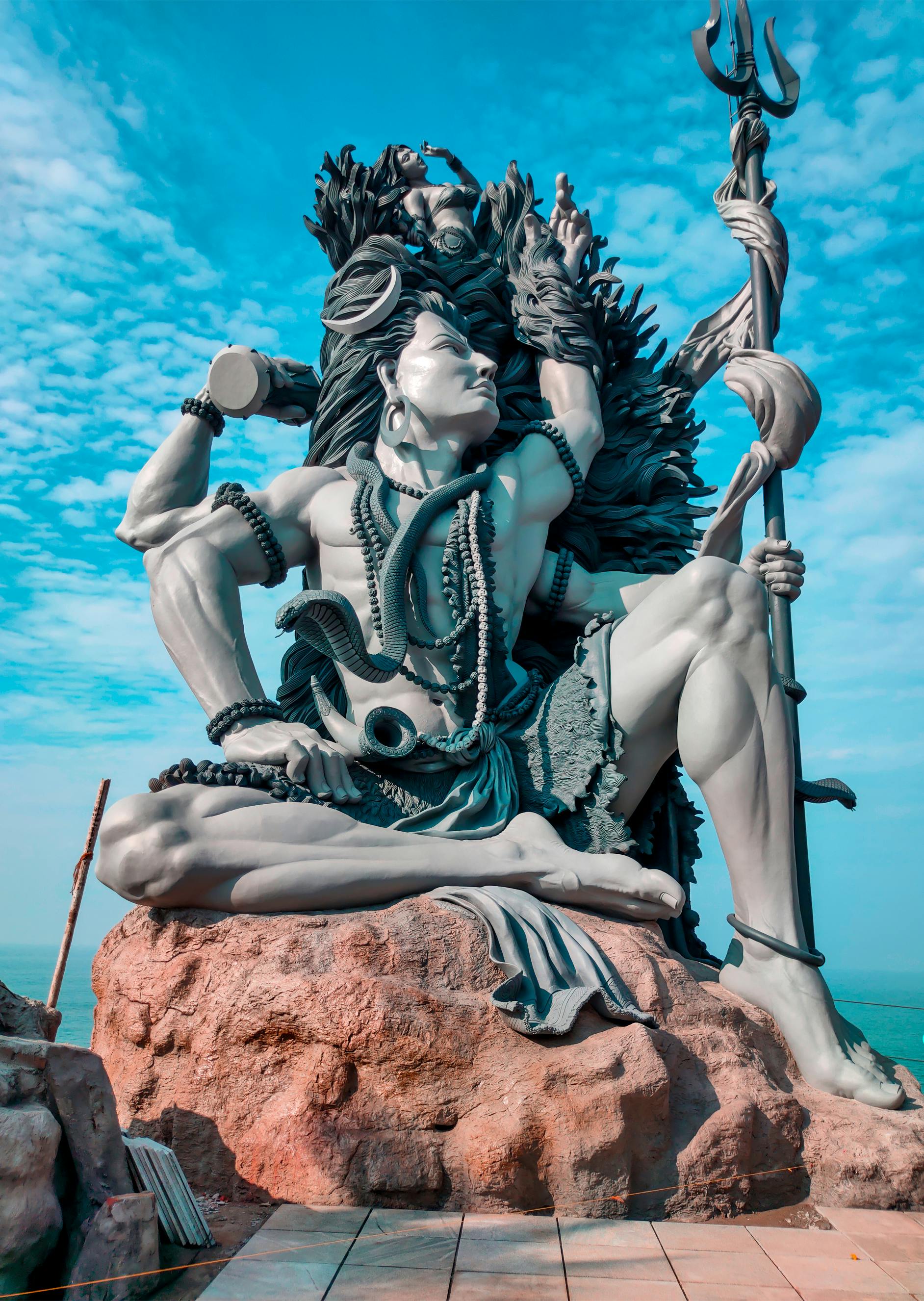 Powerful Shiva statue amidst clouds sky