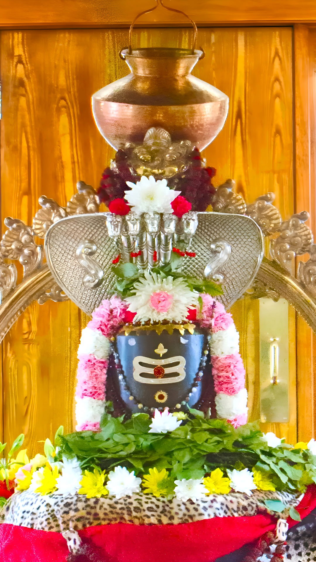 Decorated shivling with vibrant flower offerings