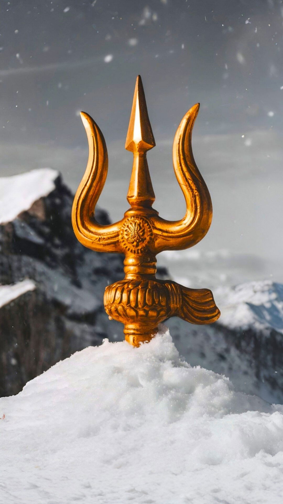 Golden Shiva Trishul on snowy mountain