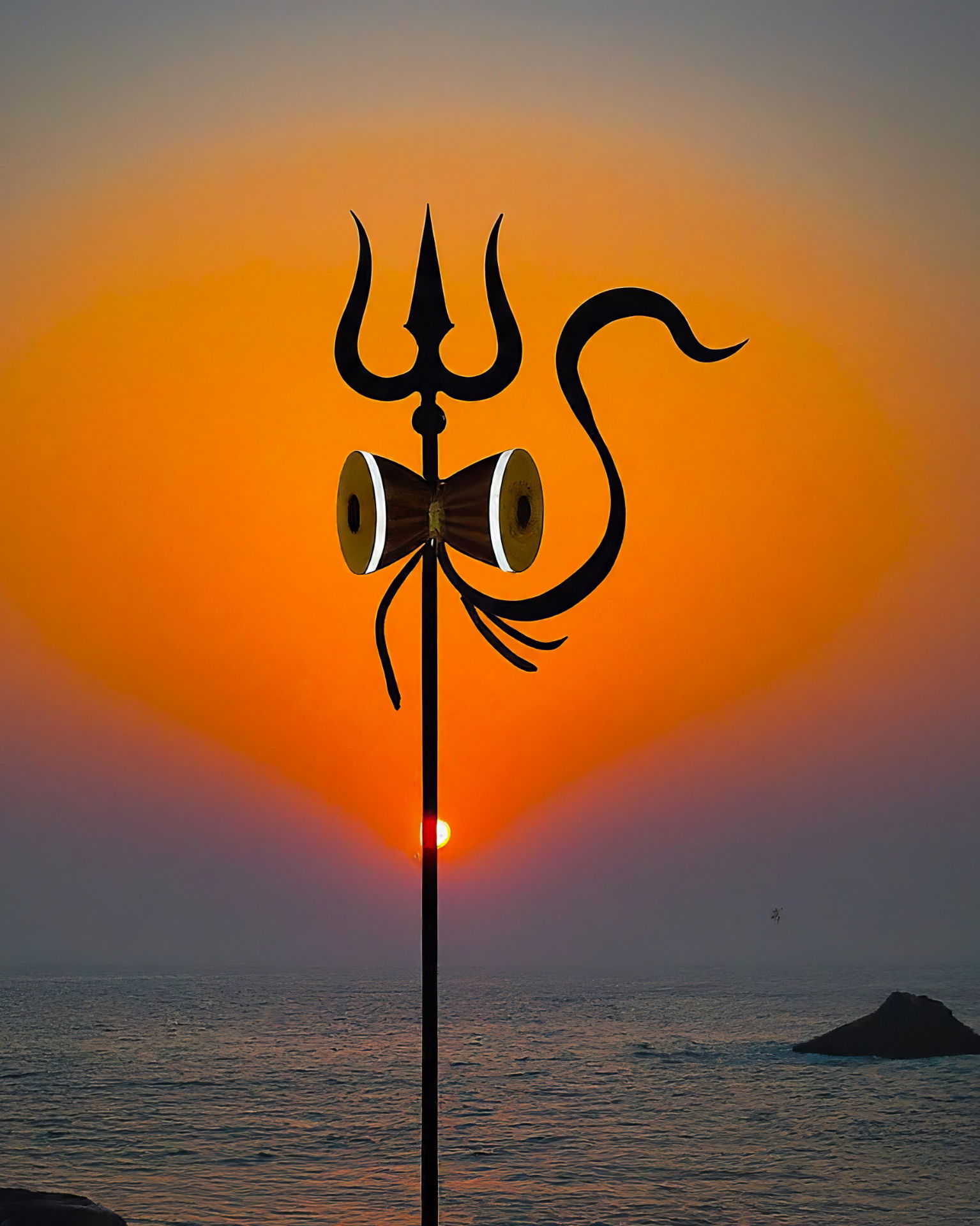 Shiva’s Trishul against a sunset sky