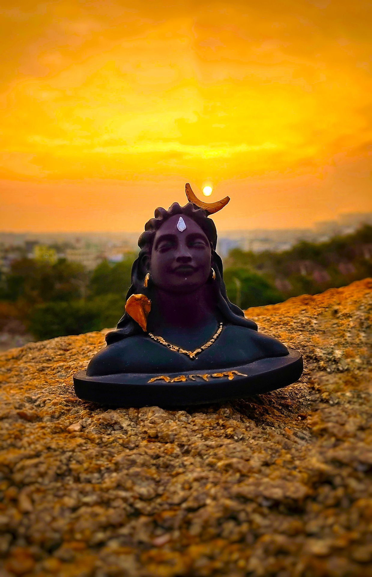 Shiva statue against a sunset backdrop