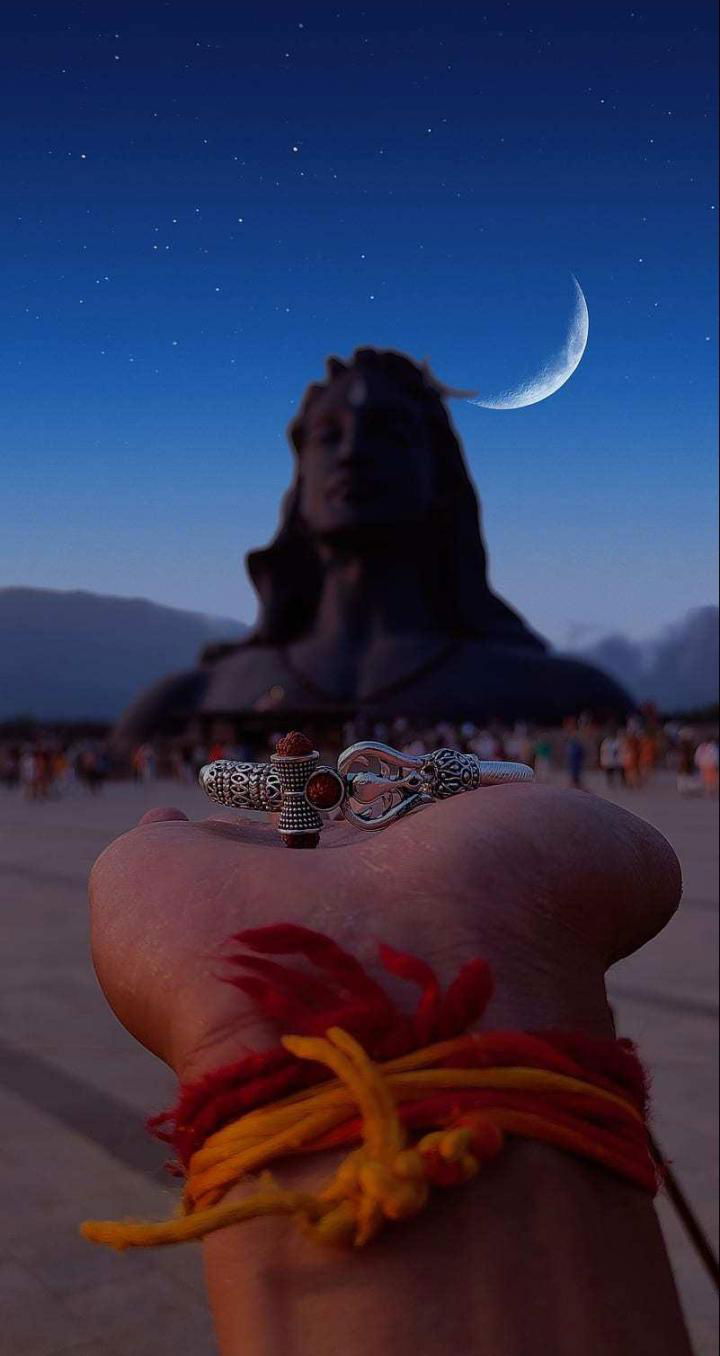 Shiva statue with Trishul under moonlight