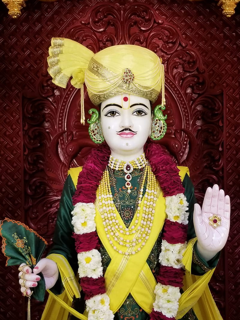 Swaminarayan with Abhaya Mudra bestows blessings.