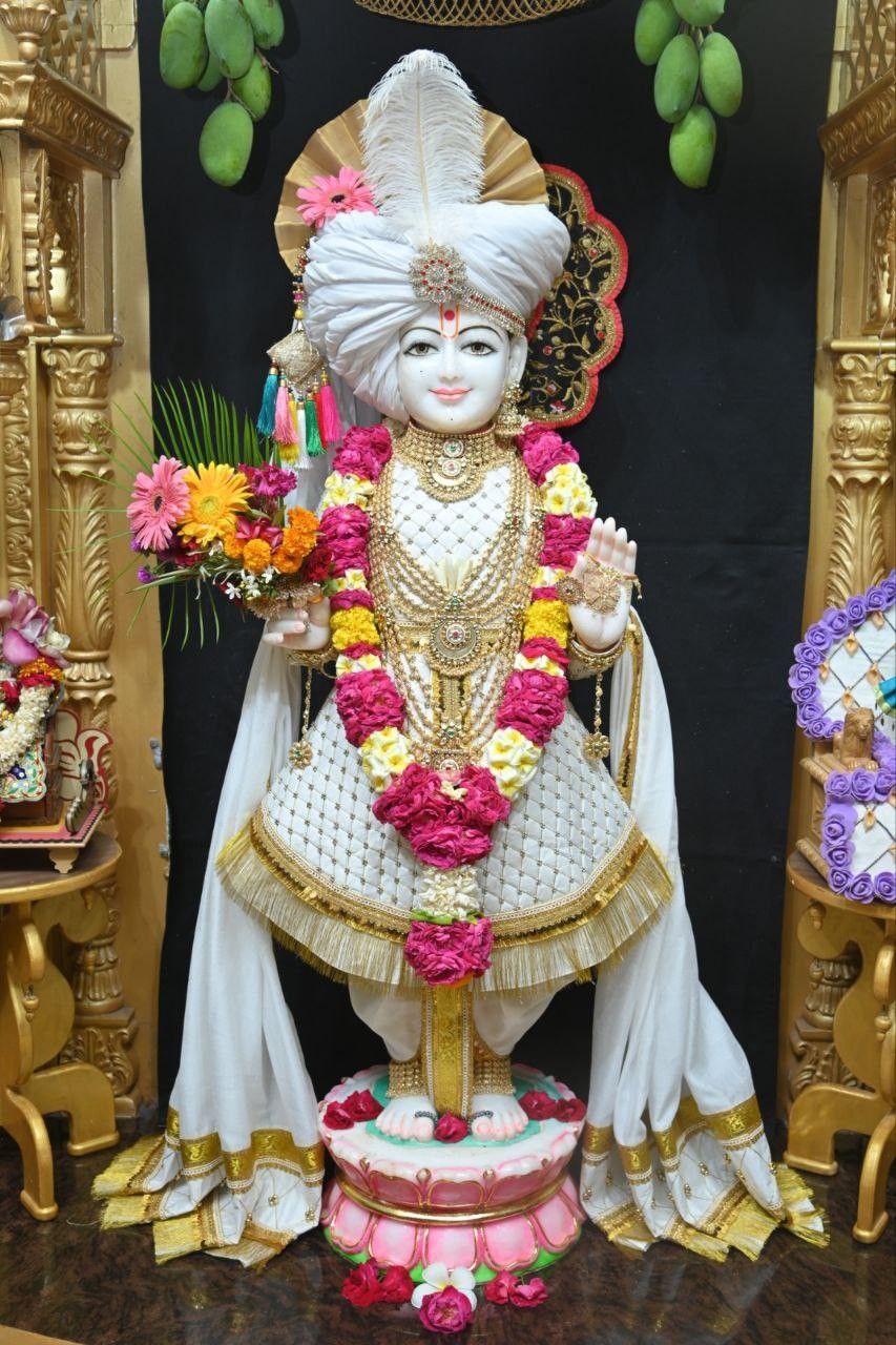 Swaminarayan statue adorned with flowers