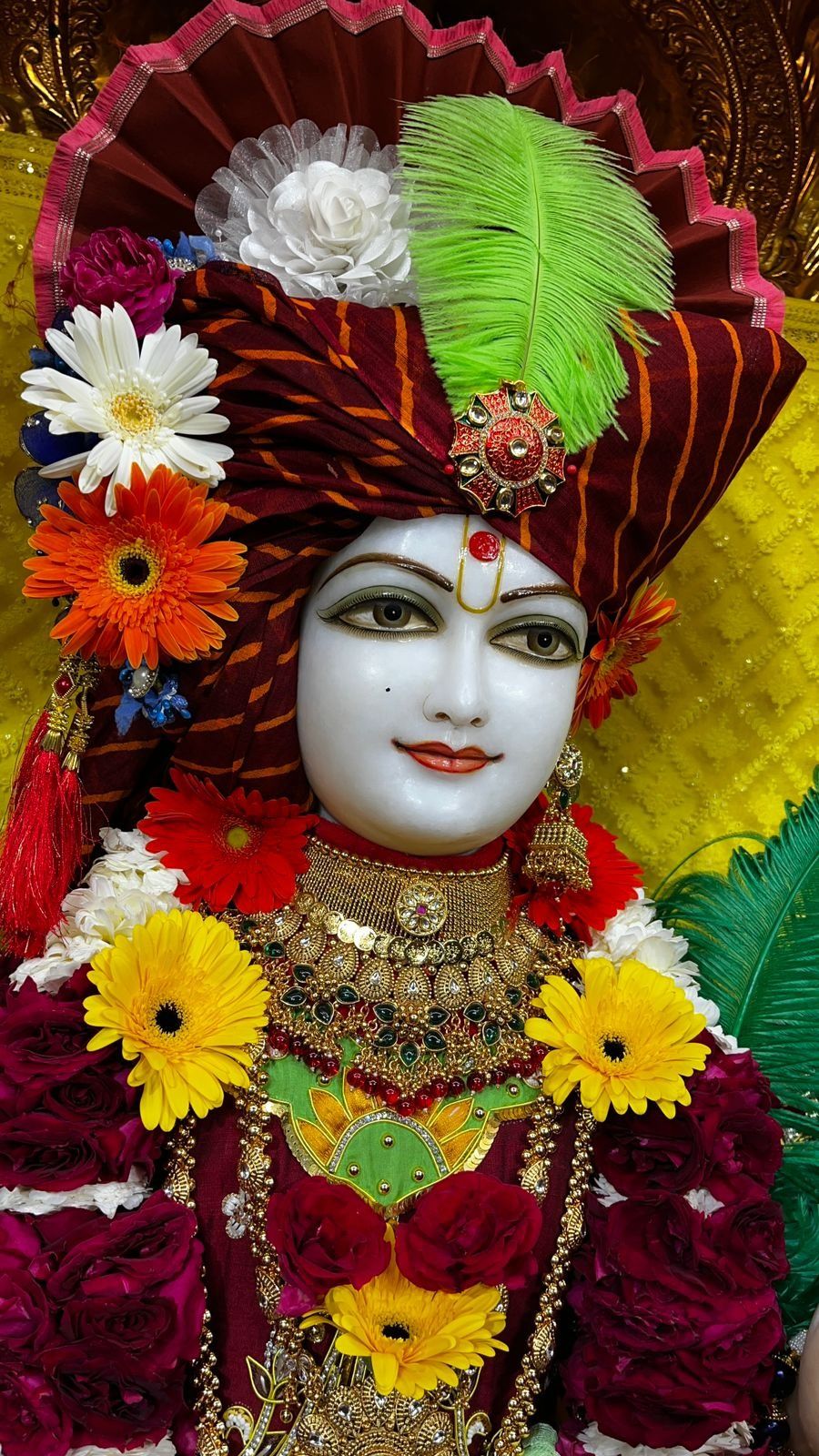 Swaminarayan with vibrant floral decorations