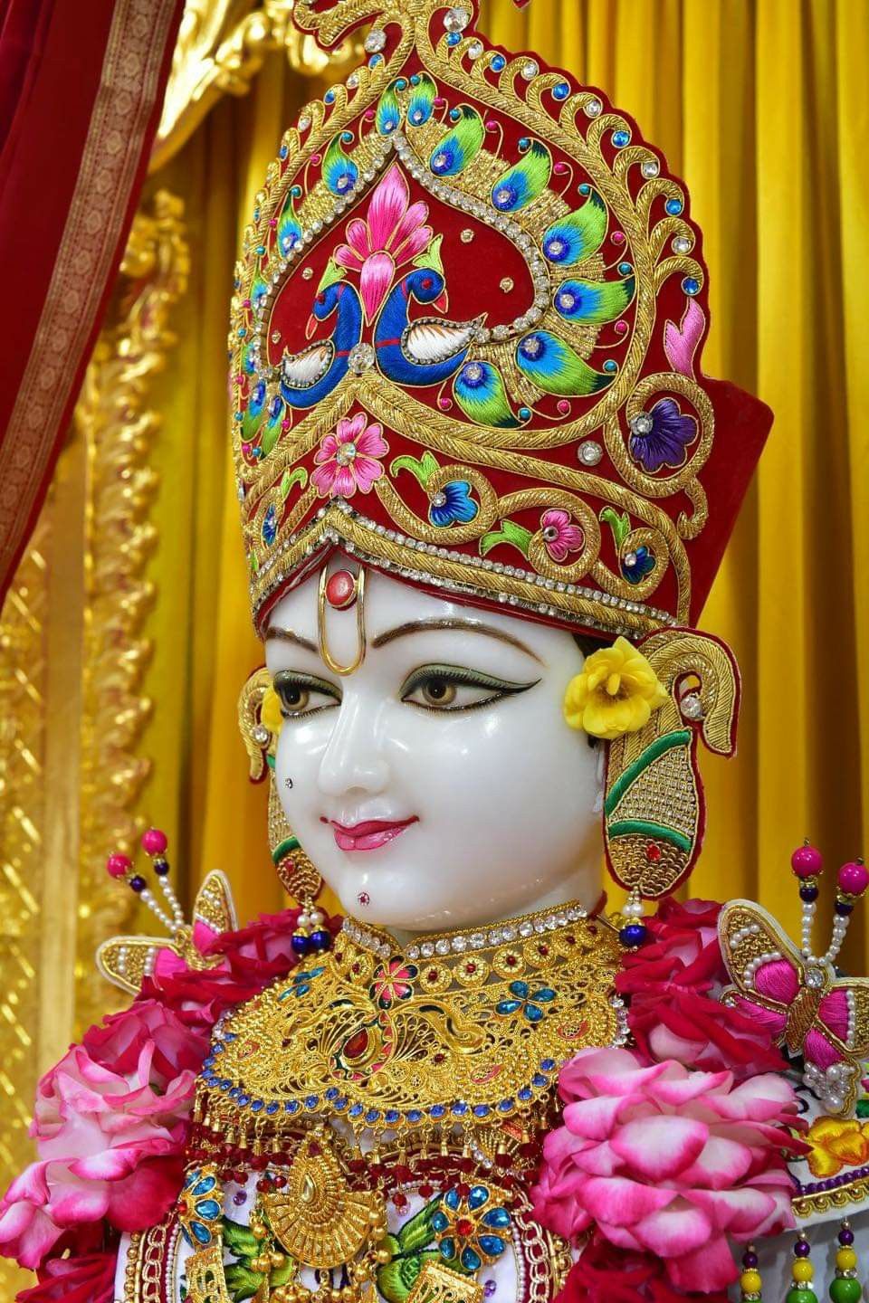 Swaminarayan deity with floral headdress
