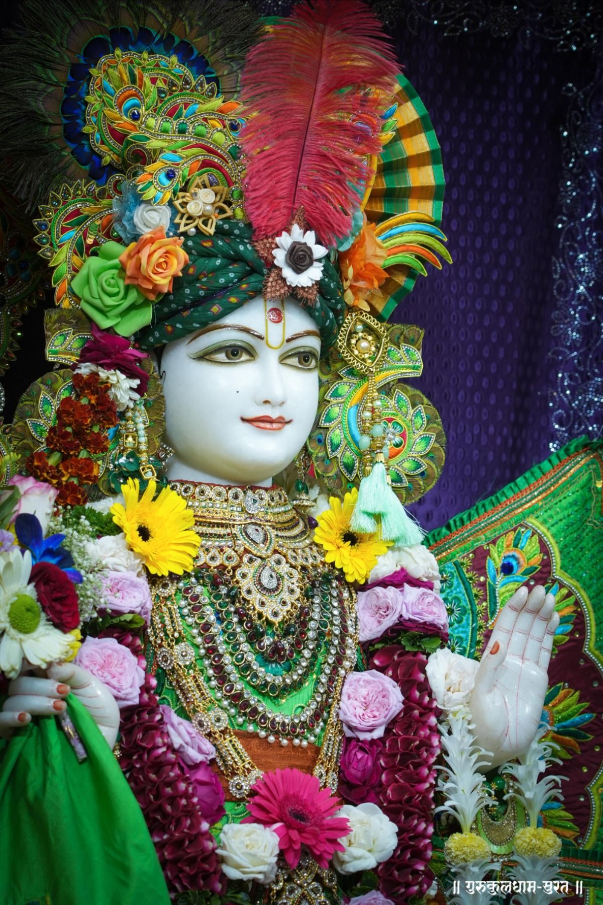 Swaminarayan adorned with floral crown.