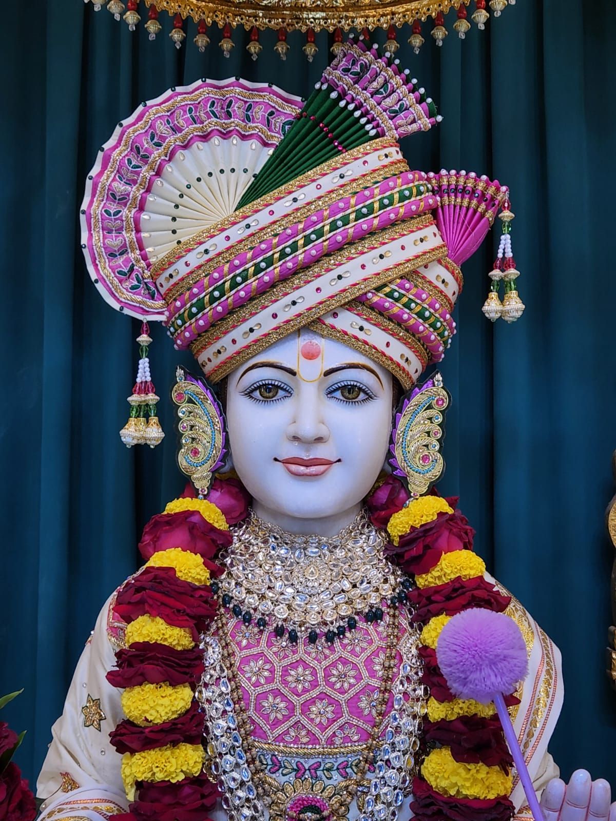 Swaminarayan with ornate floral headgear