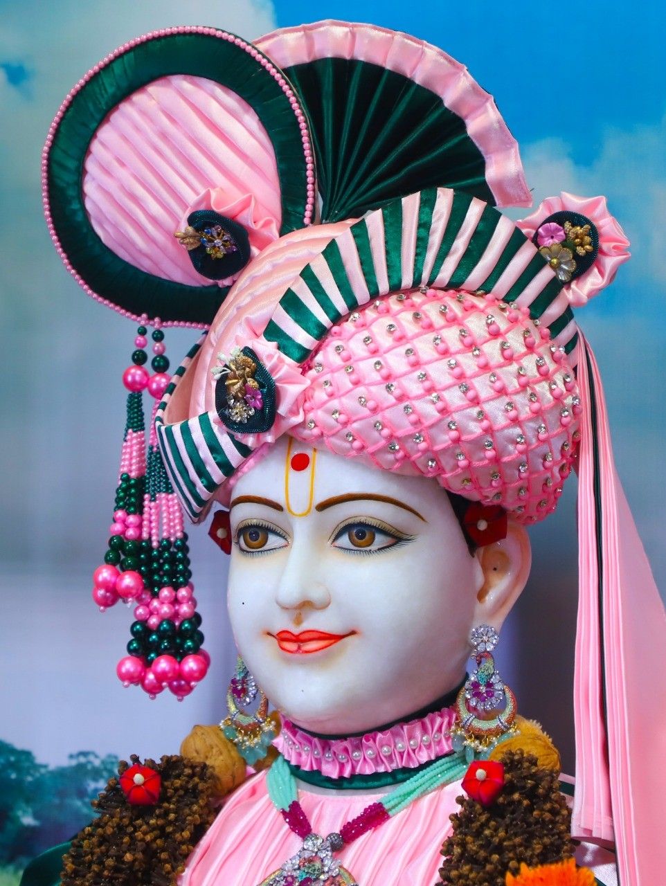 Swaminarayan with exquisite pink and green headgear