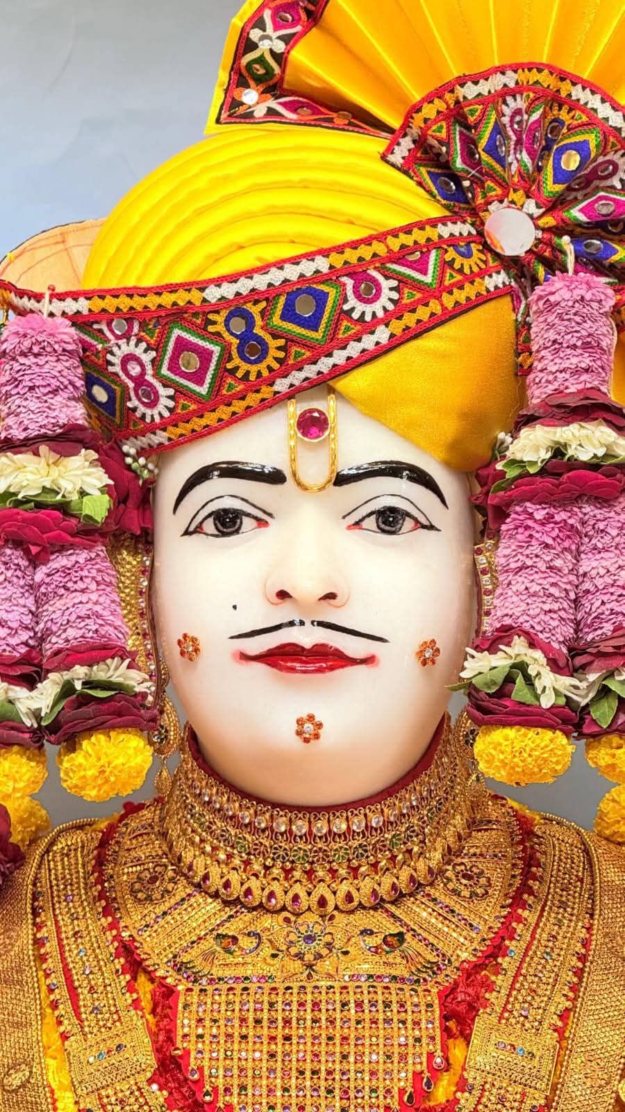 Swaminarayan portrait with floral adornments