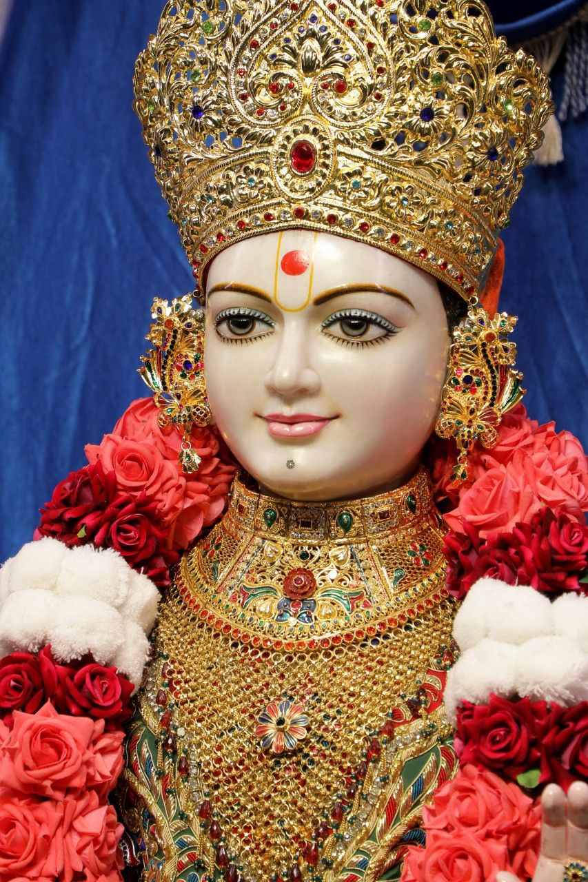 Swaminarayan with golden crown and flowers