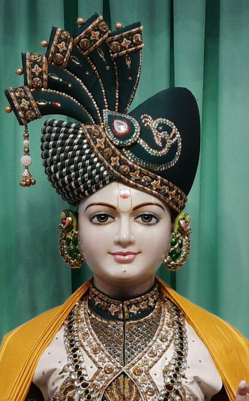 Swaminarayan with ornate headpiece and jewelry