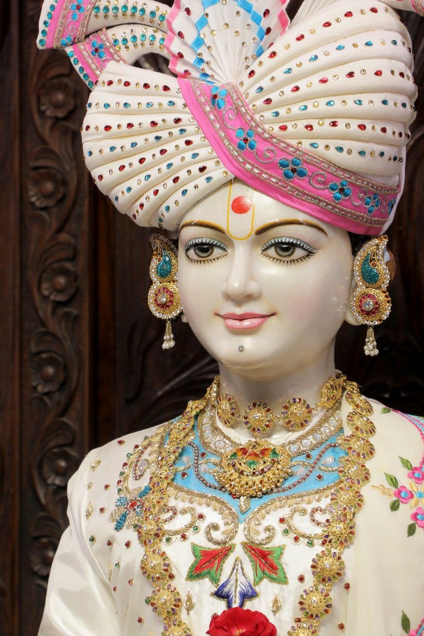 Swaminarayan with ornate turban and jewelry.