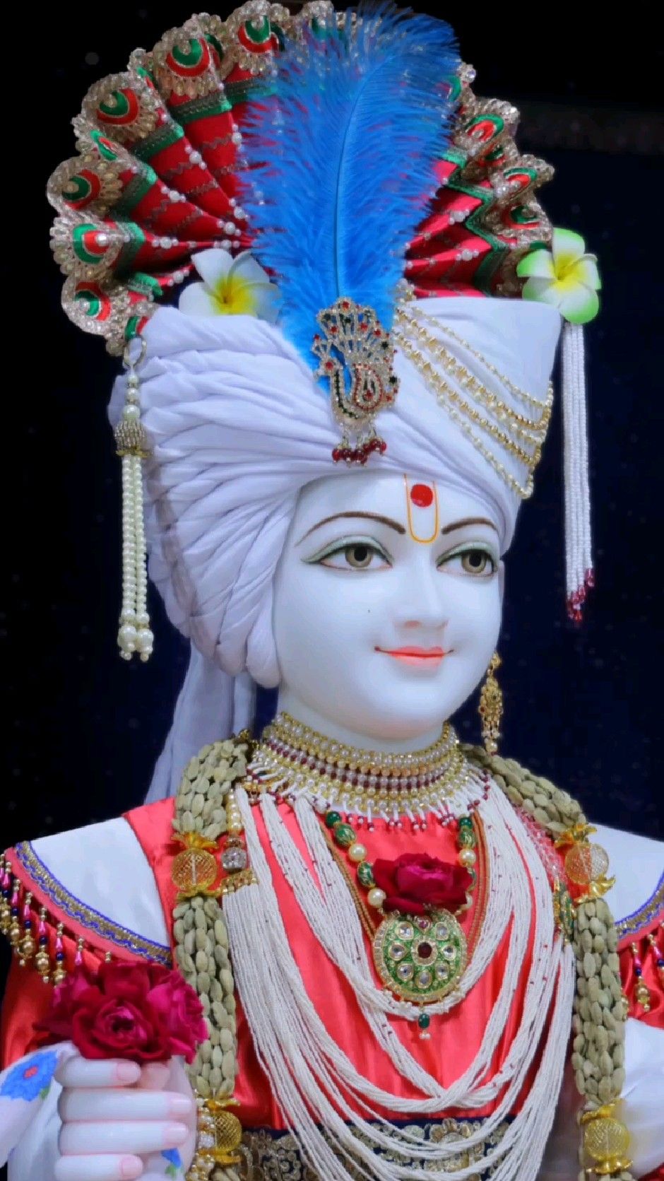Swaminarayan with ornate headwear and necklace