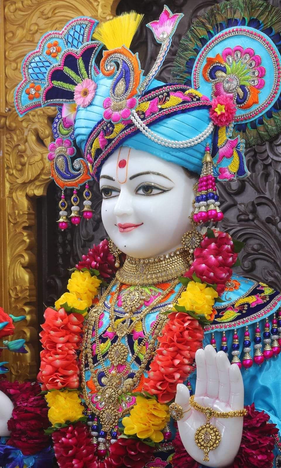 Swaminarayan deity with floral decorations