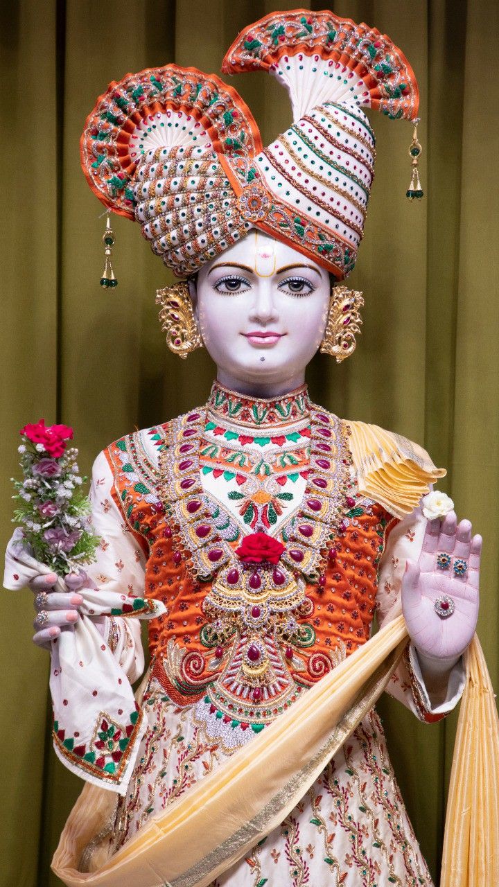 Radiant Swaminarayan with floral crown.