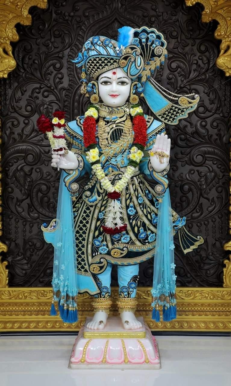 Swaminarayan deity with floral offerings