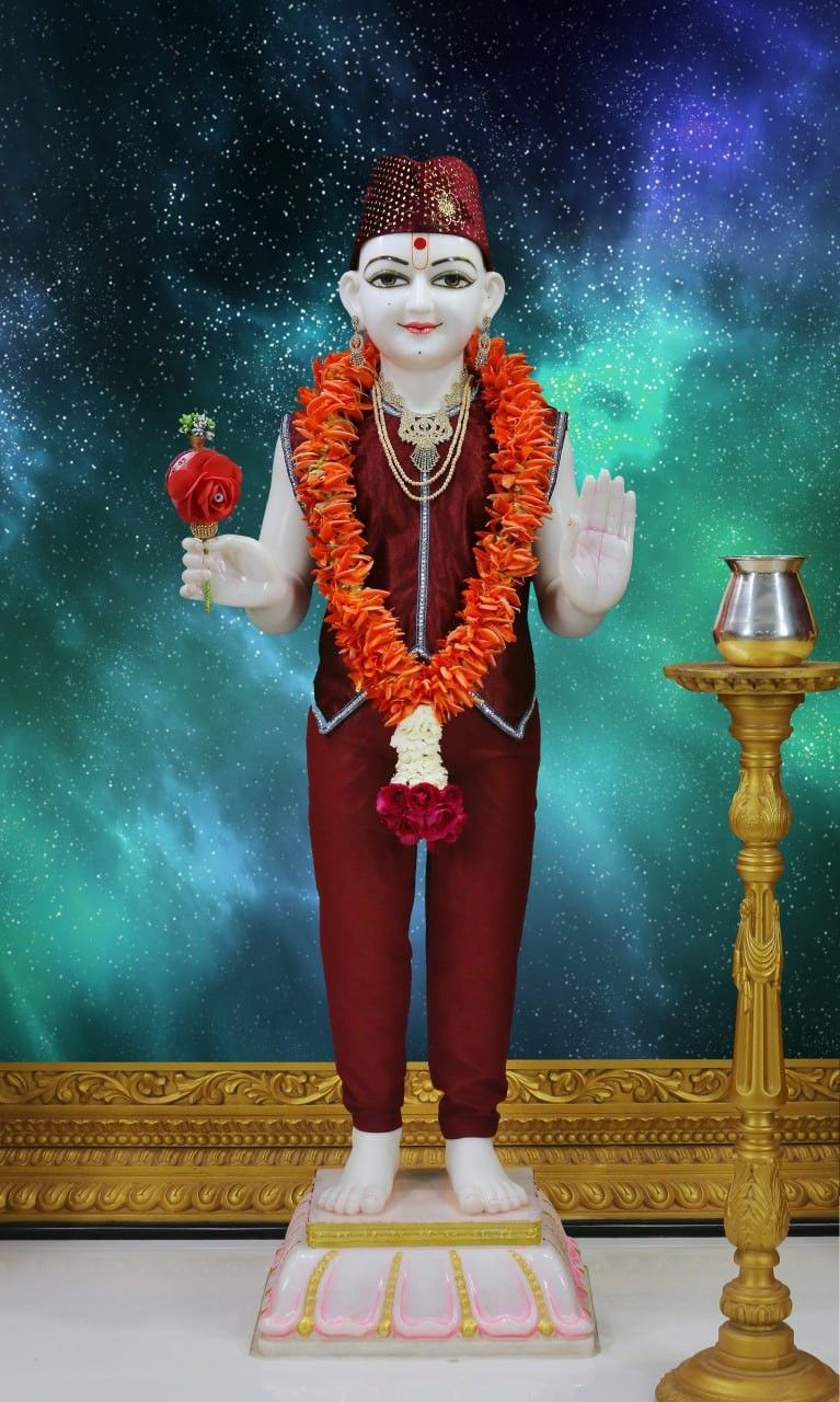 Swaminarayan statue with cosmic backdrop