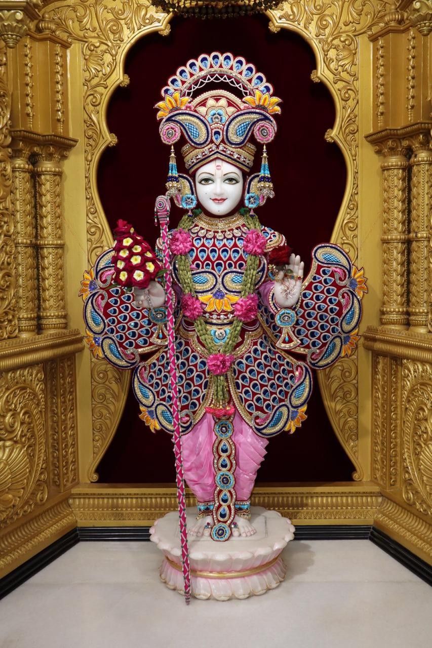Swaminarayan idol in ornate temple setting