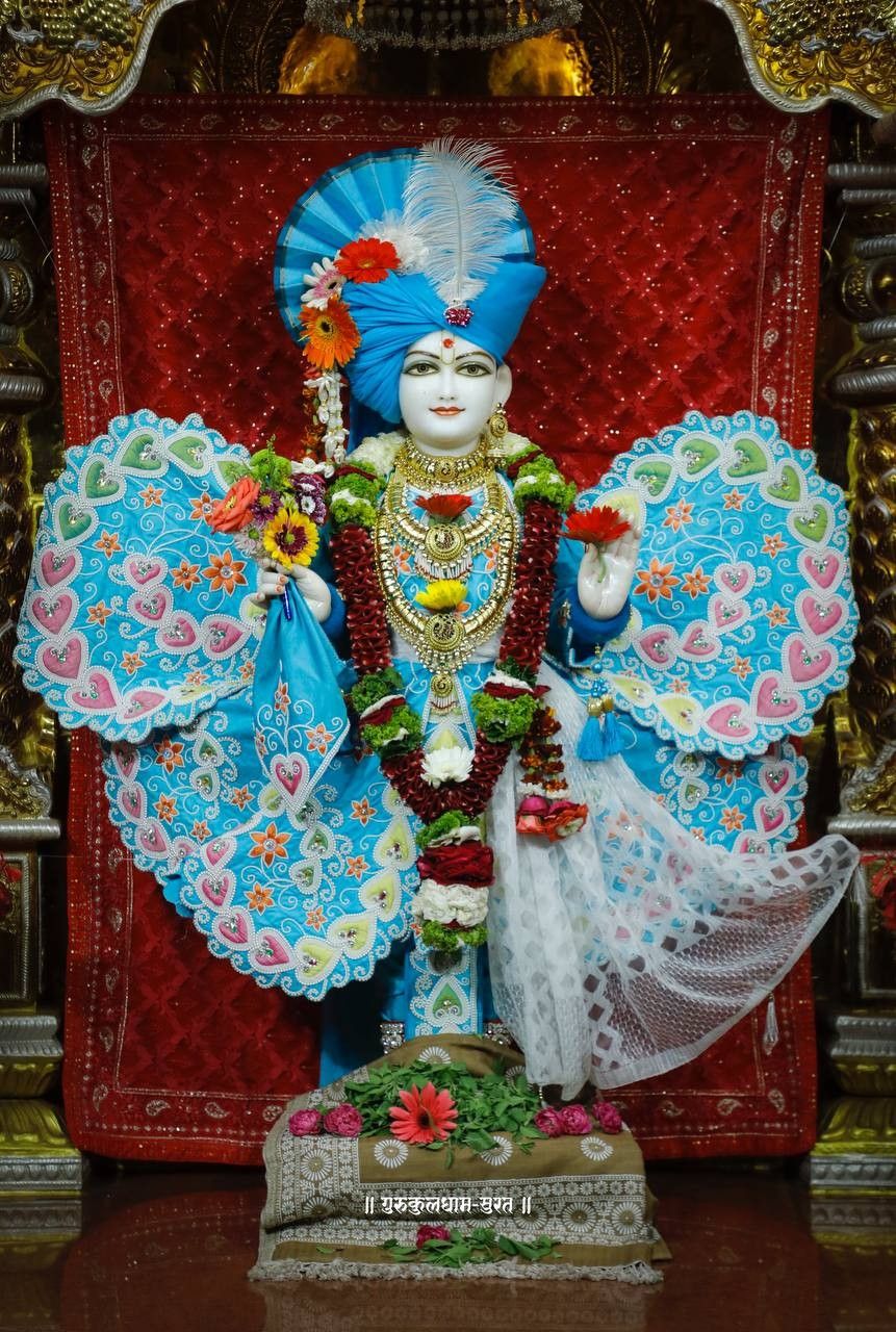 Swaminarayan deity with floral adornments.