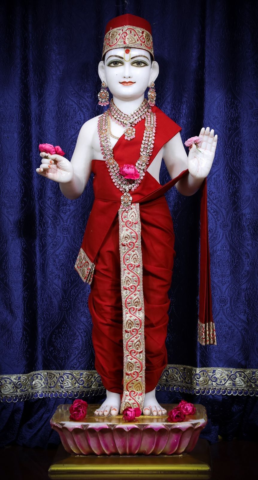 Swaminarayan idol adorned with jewels flowers