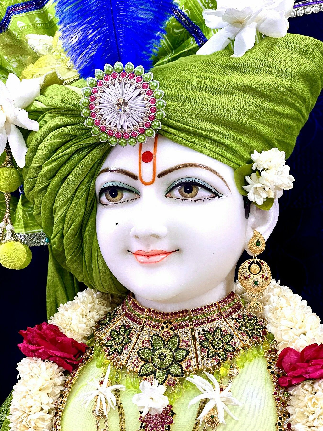 Swaminarayan with floral garland and turban