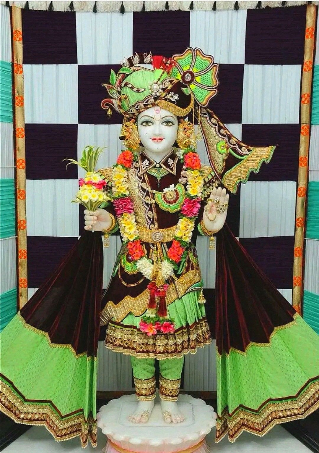 Swaminarayan deity with floral decorations