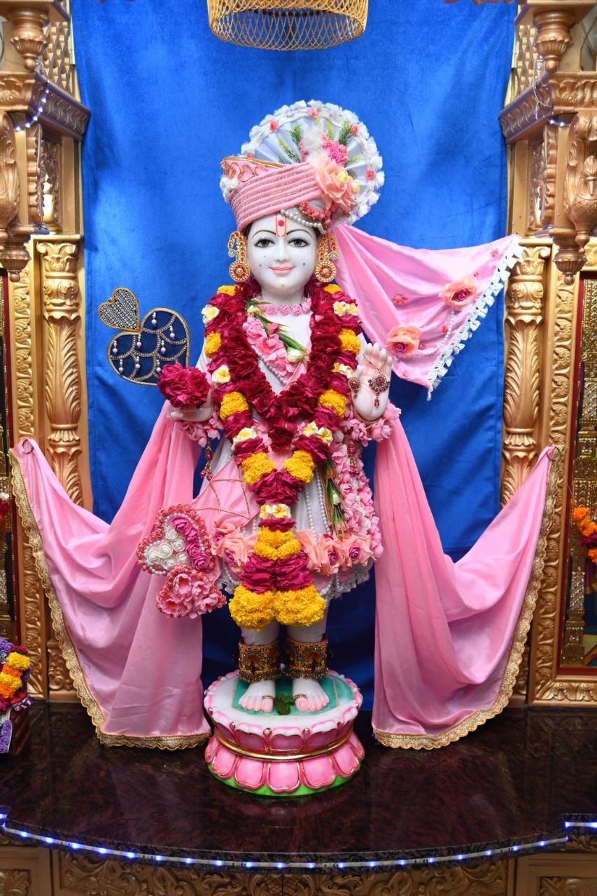 Swaminarayan statue adorned with flowers