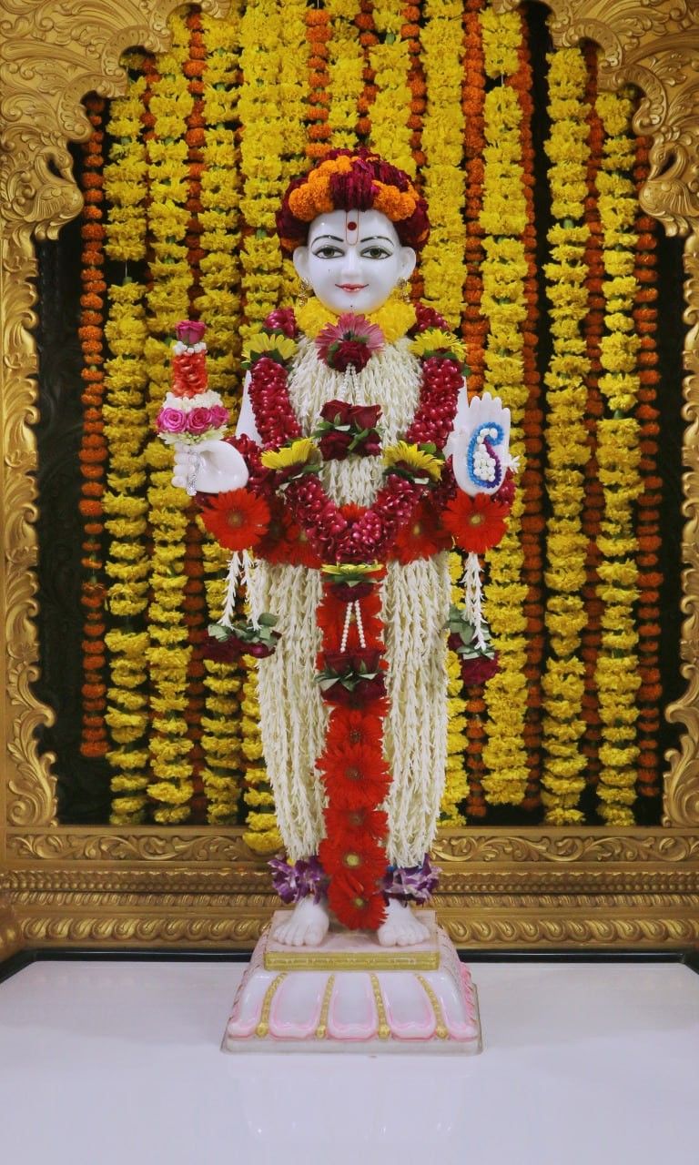 Swaminarayan statue with flower garland