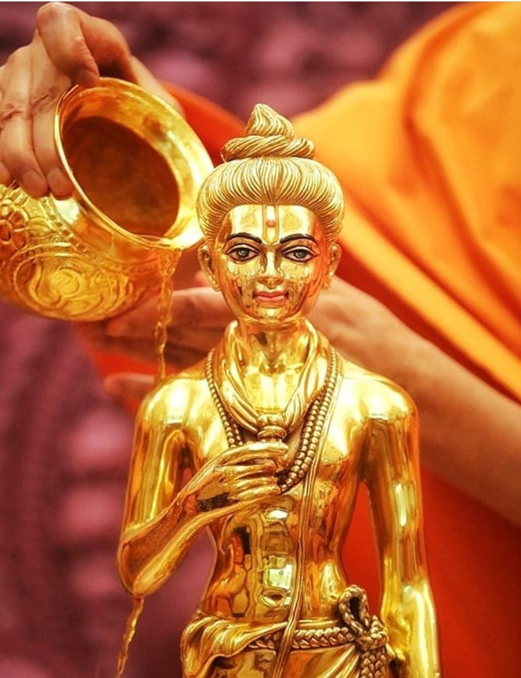 Swaminarayan idol receiving golden abhishek