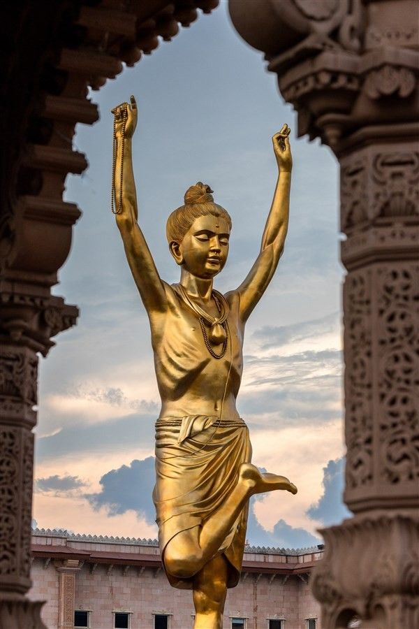 Golden Swaminarayan statue at temple.