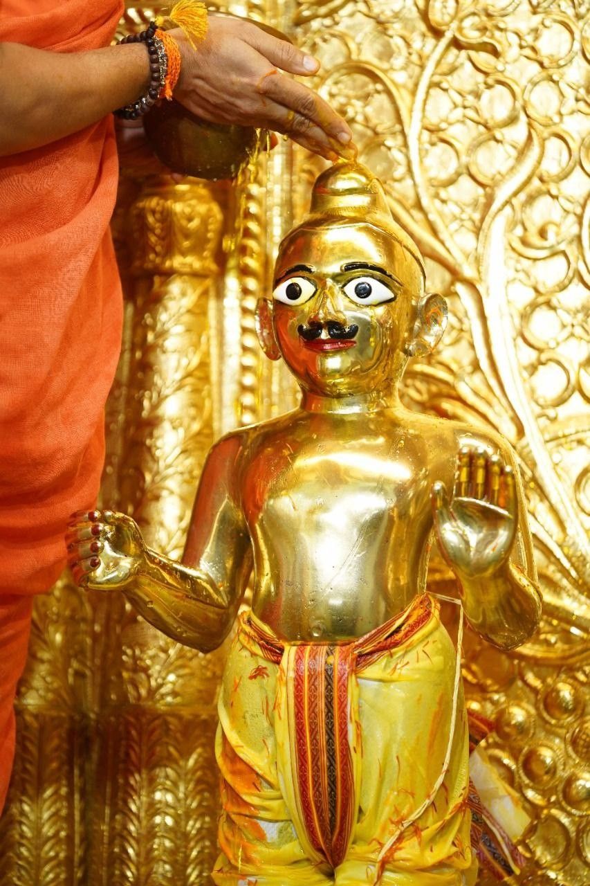 Golden Swaminarayan idol radiating divine grace.