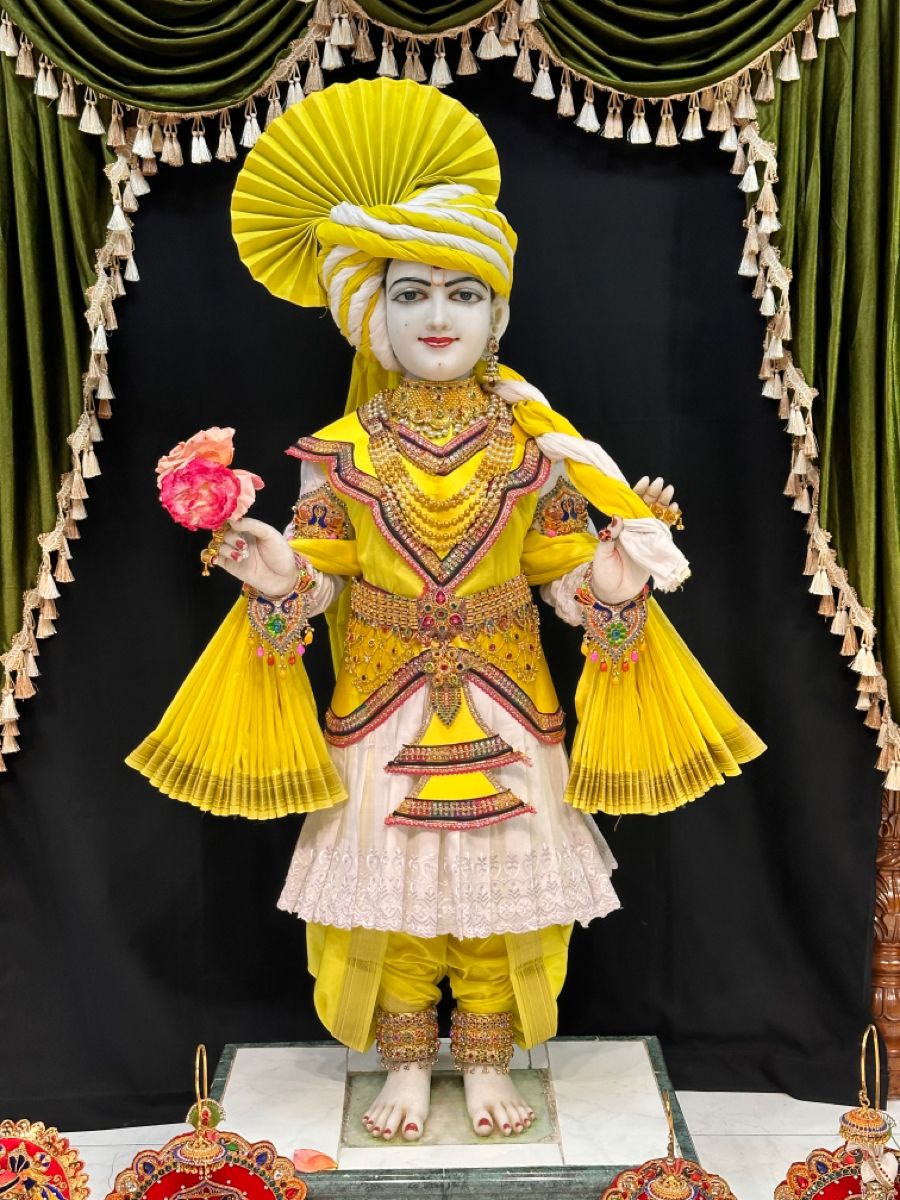 Swaminarayan in ornate yellow attire
