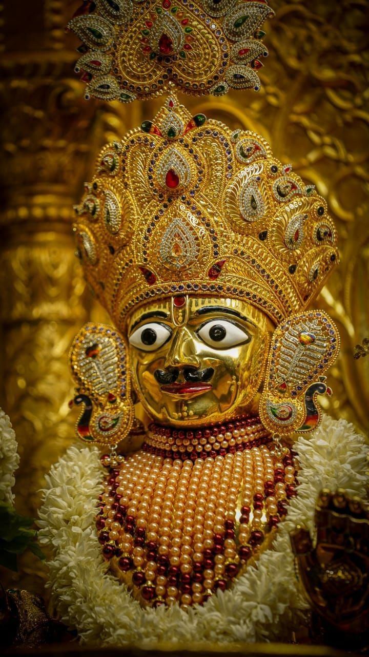 Golden Swaminarayan face with jeweled crown