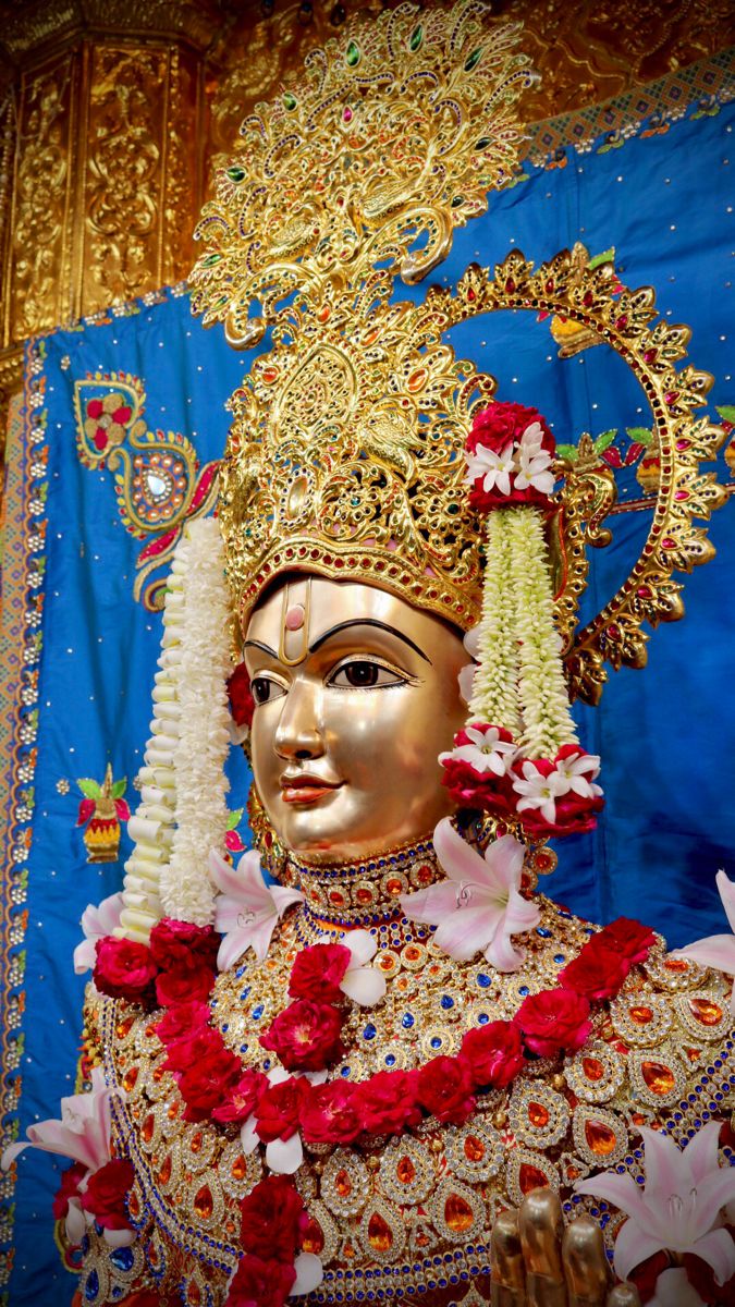 Swaminarayan with golden crown and flowers