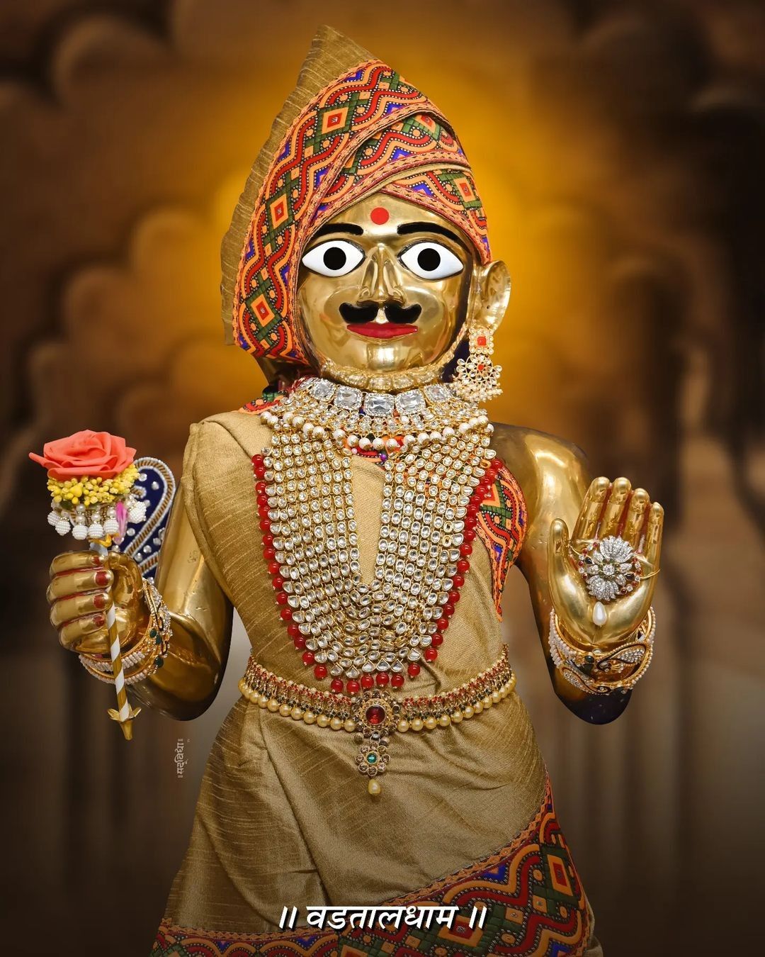 Golden Swaminarayan with floral garland