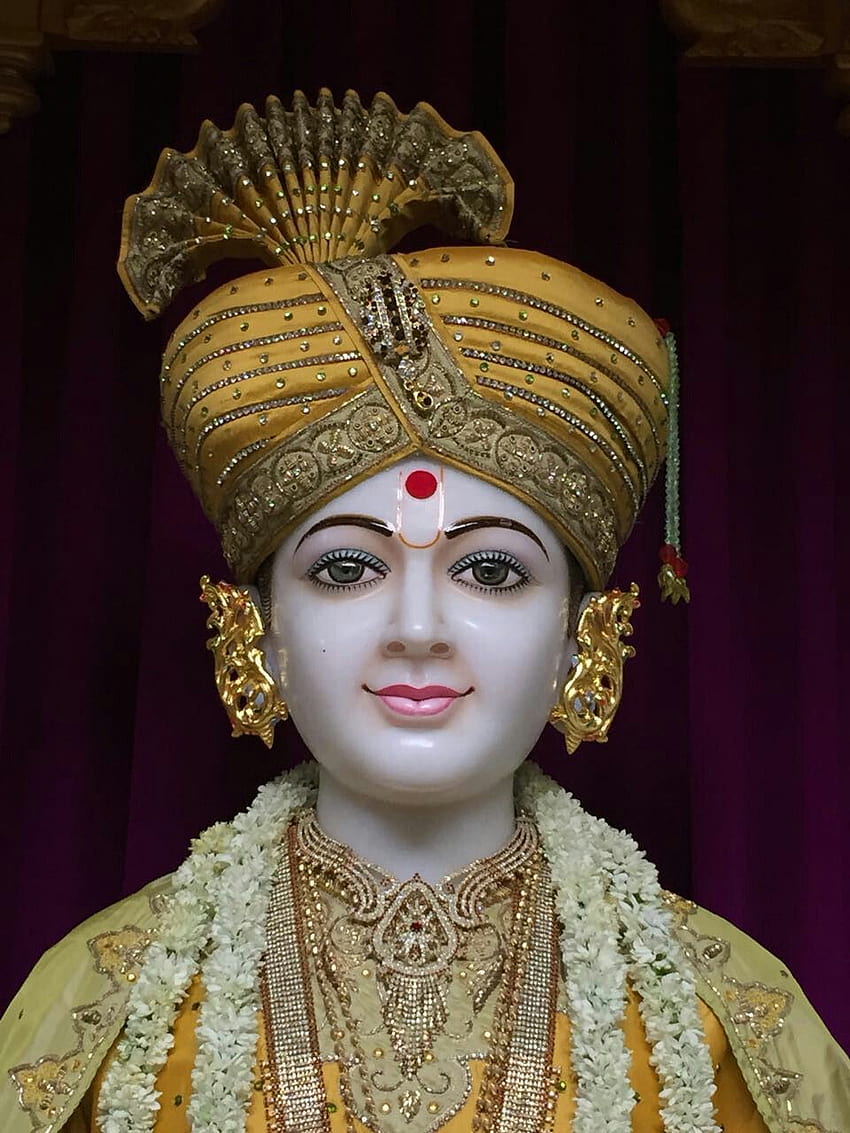 Swaminarayan with golden mukut and garland.
