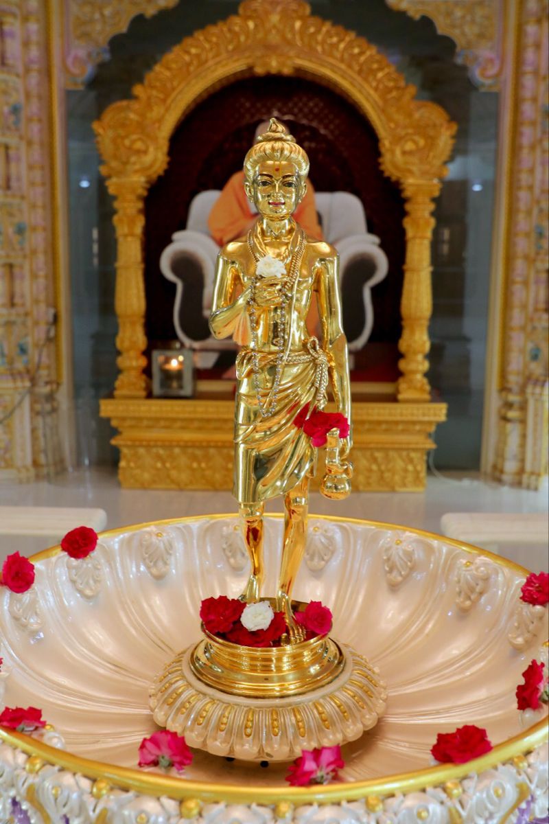 Golden Swaminarayan murti in temple setting