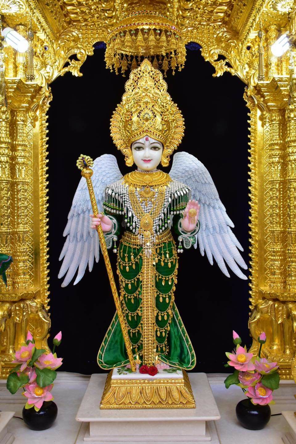 Swaminarayan with golden crown and lotus.