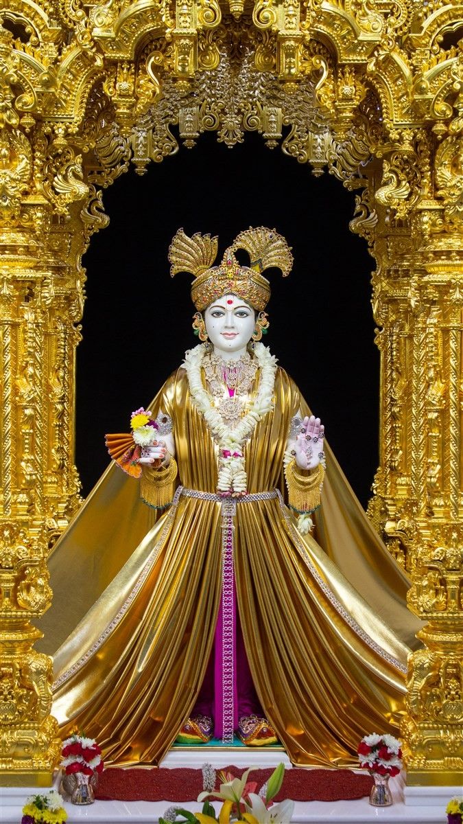 Swaminarayan in golden attire, devotional image.