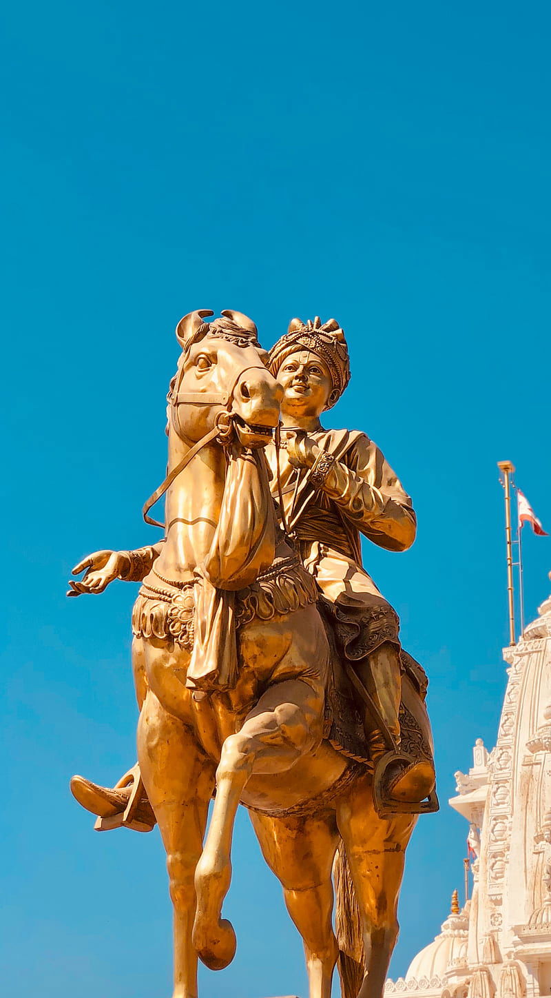 Swaminarayan Maharaj riding a golden horse