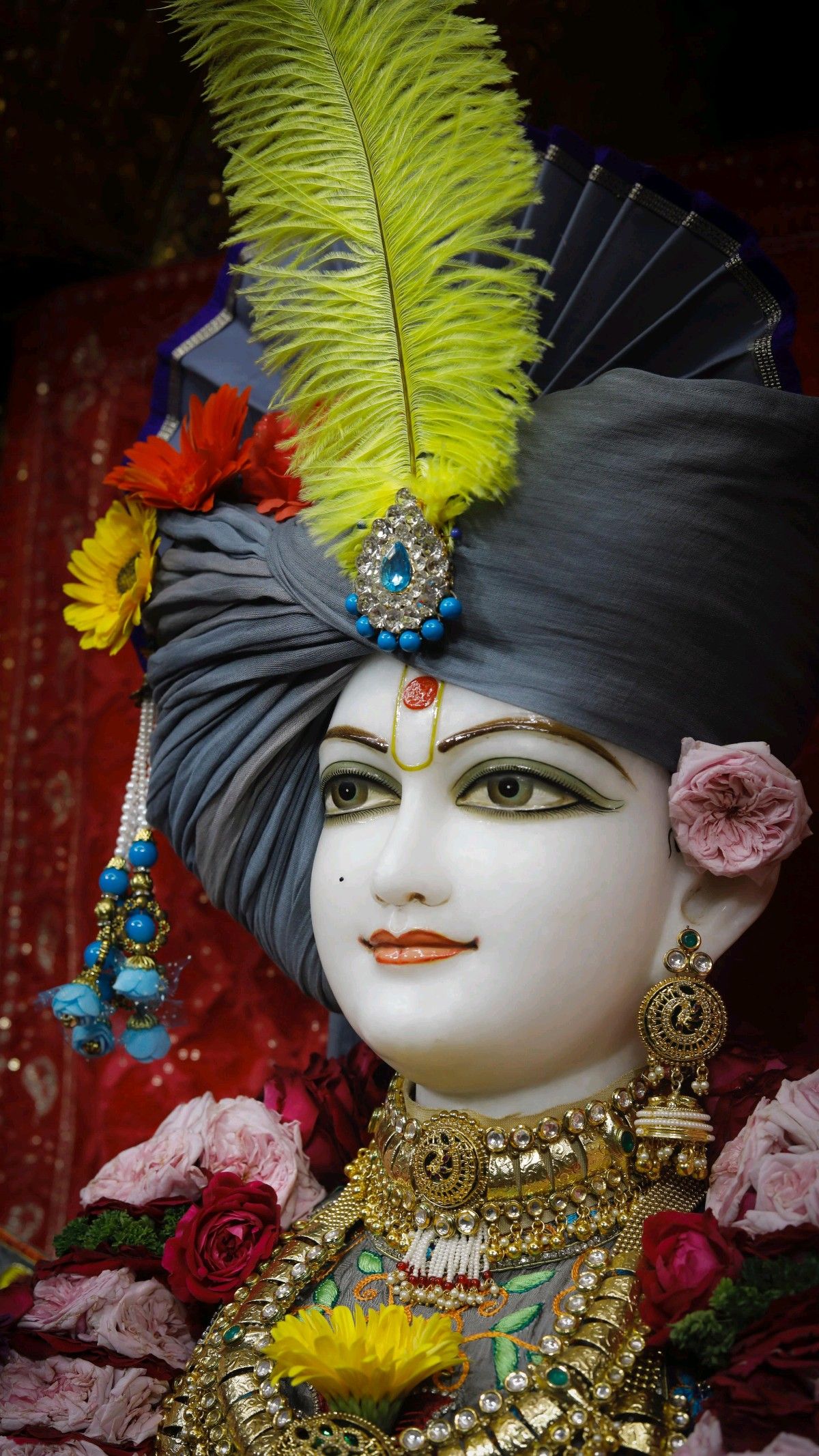 Swaminarayan with floral decorations and jewels