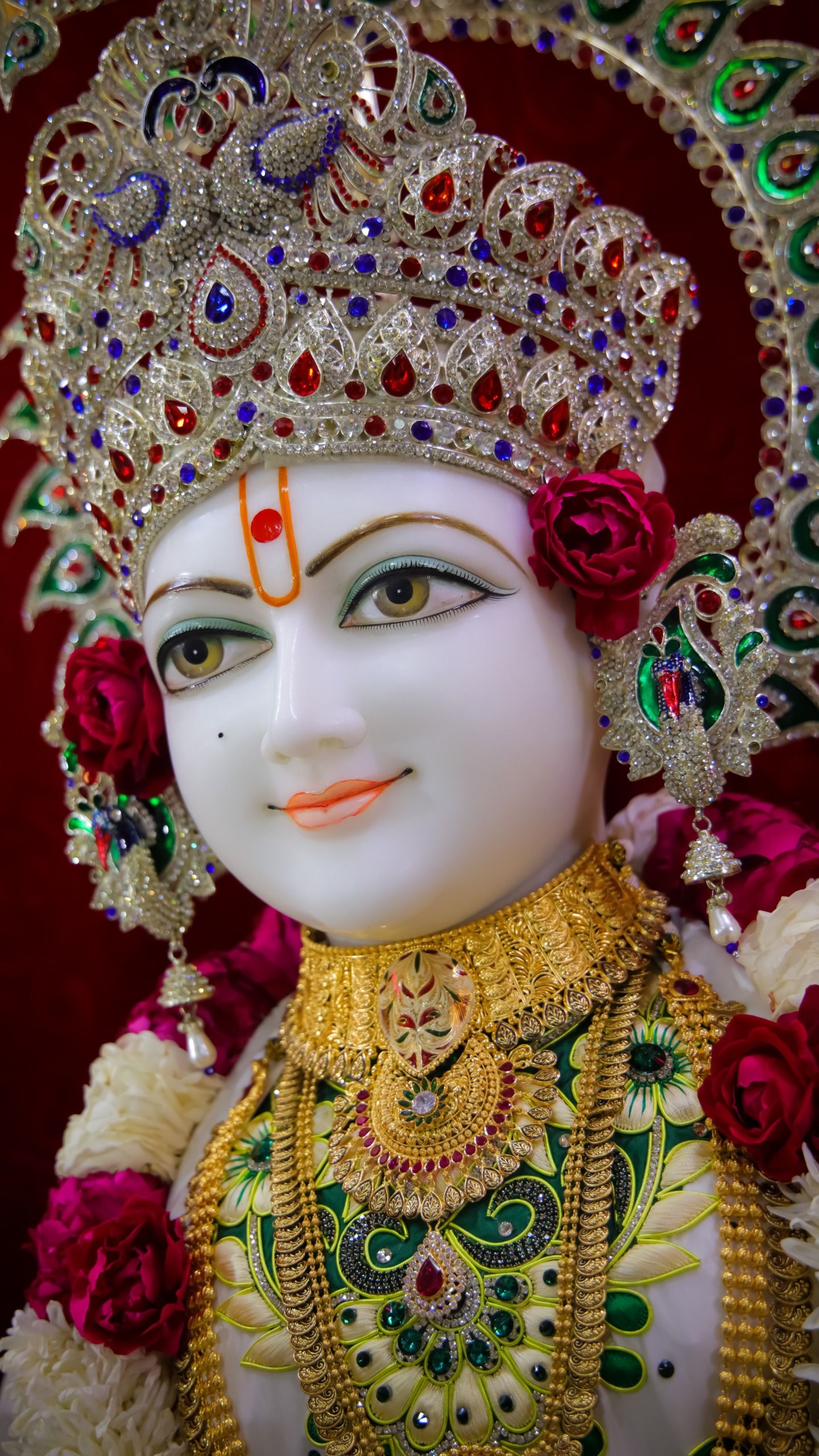 Swaminarayan with jeweled crown and flowers