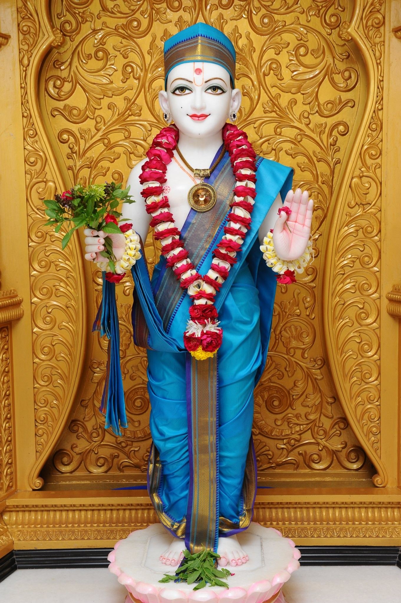 Swaminarayan murti adorned with flowers