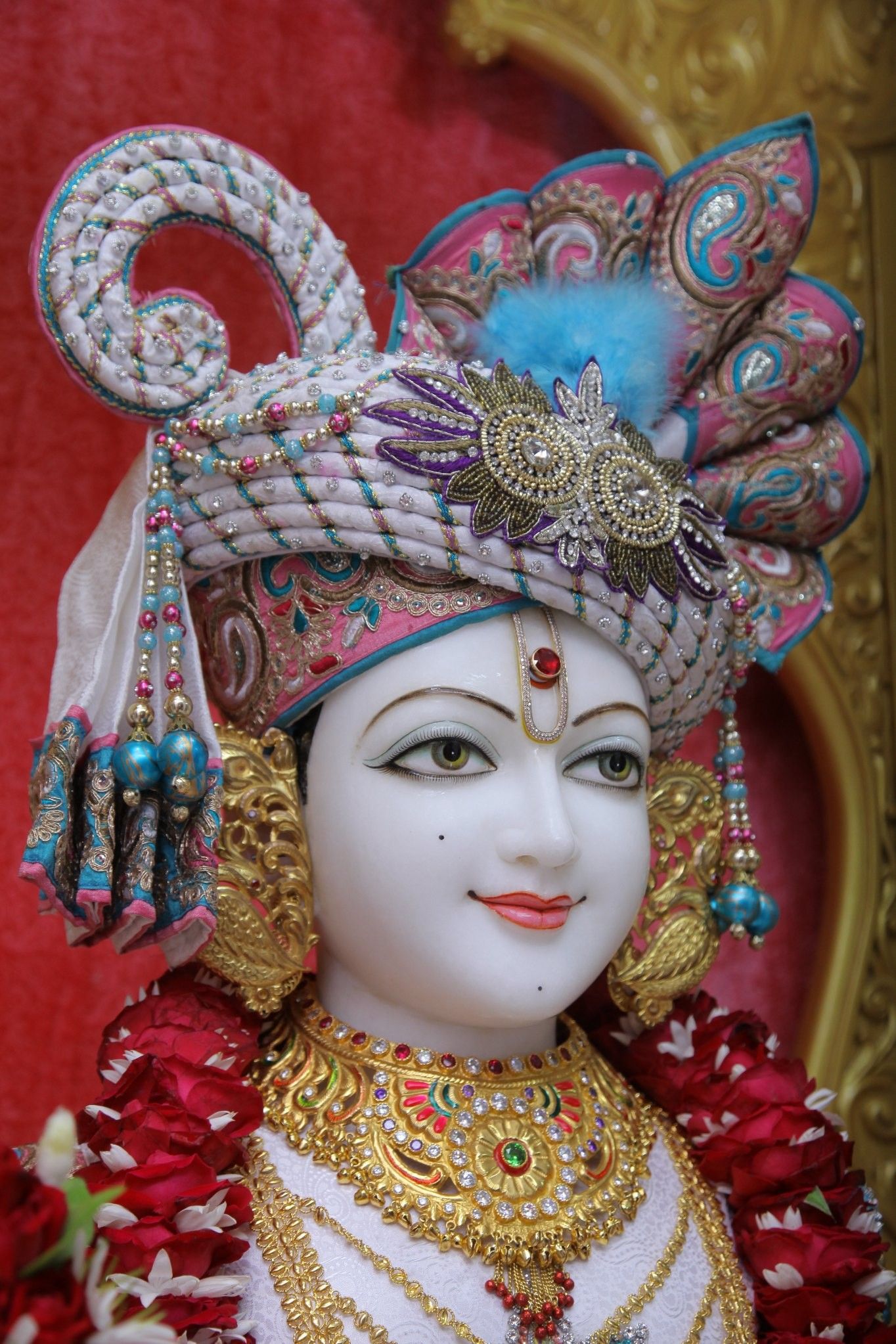 Swaminarayan Bhagwan with ornate headdress.