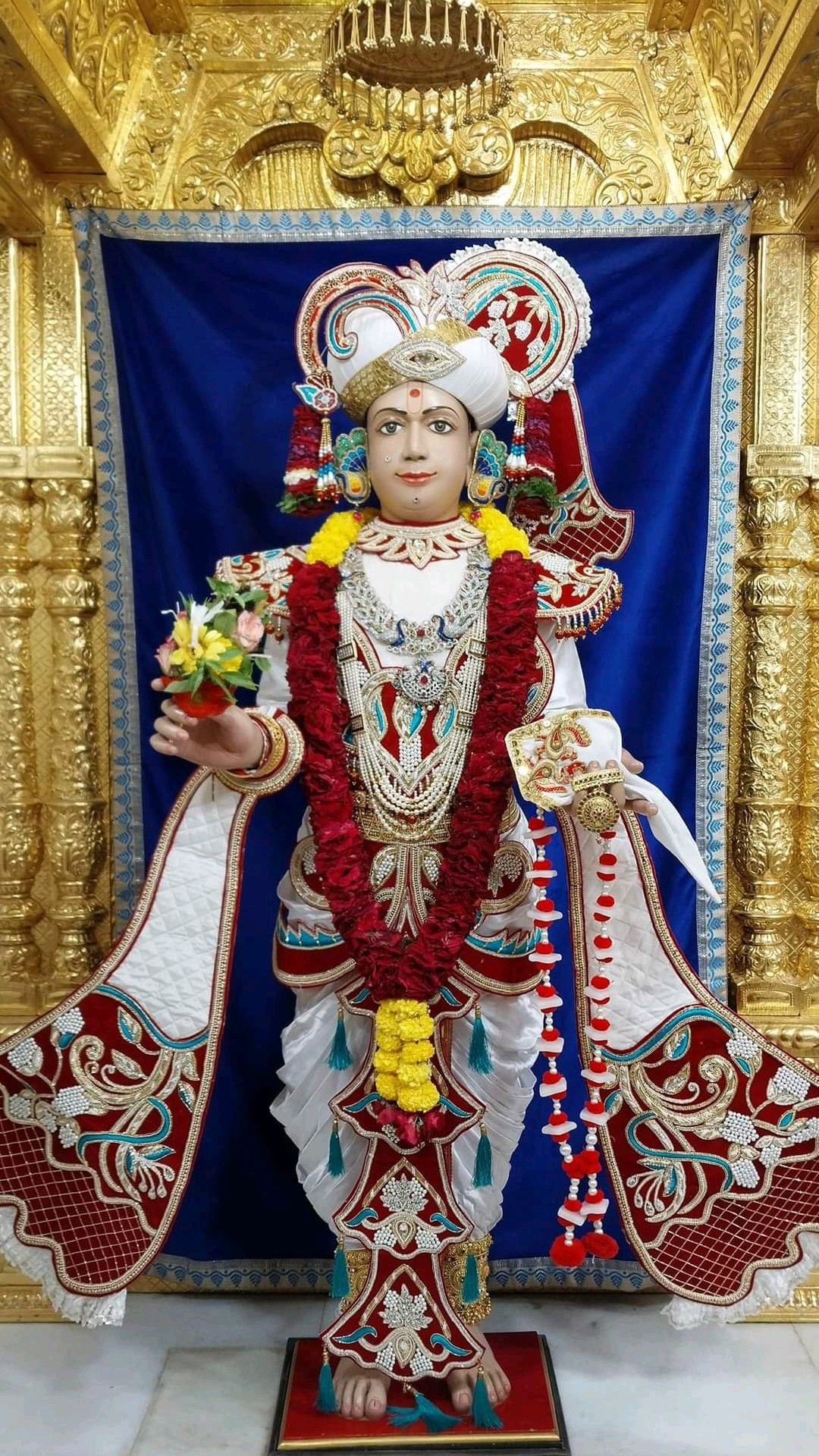 Swaminarayan idol adorned with flowers