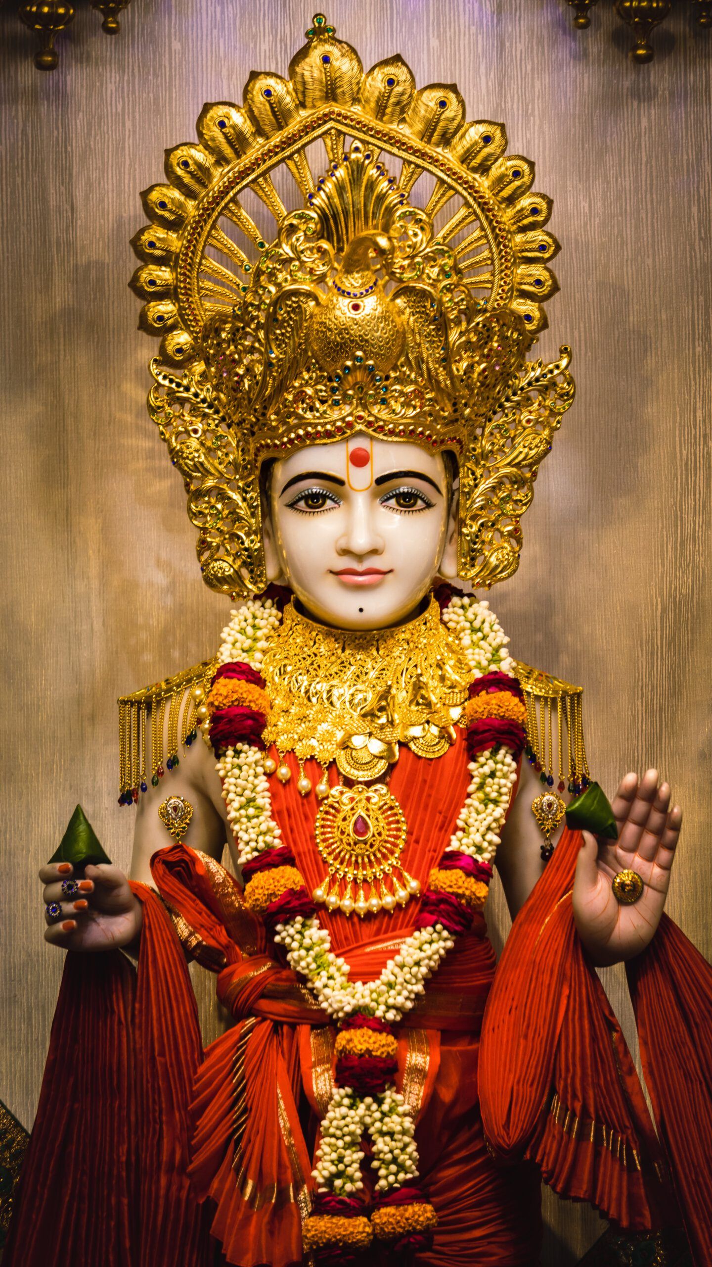 Swaminarayan with golden mukut and floral garland