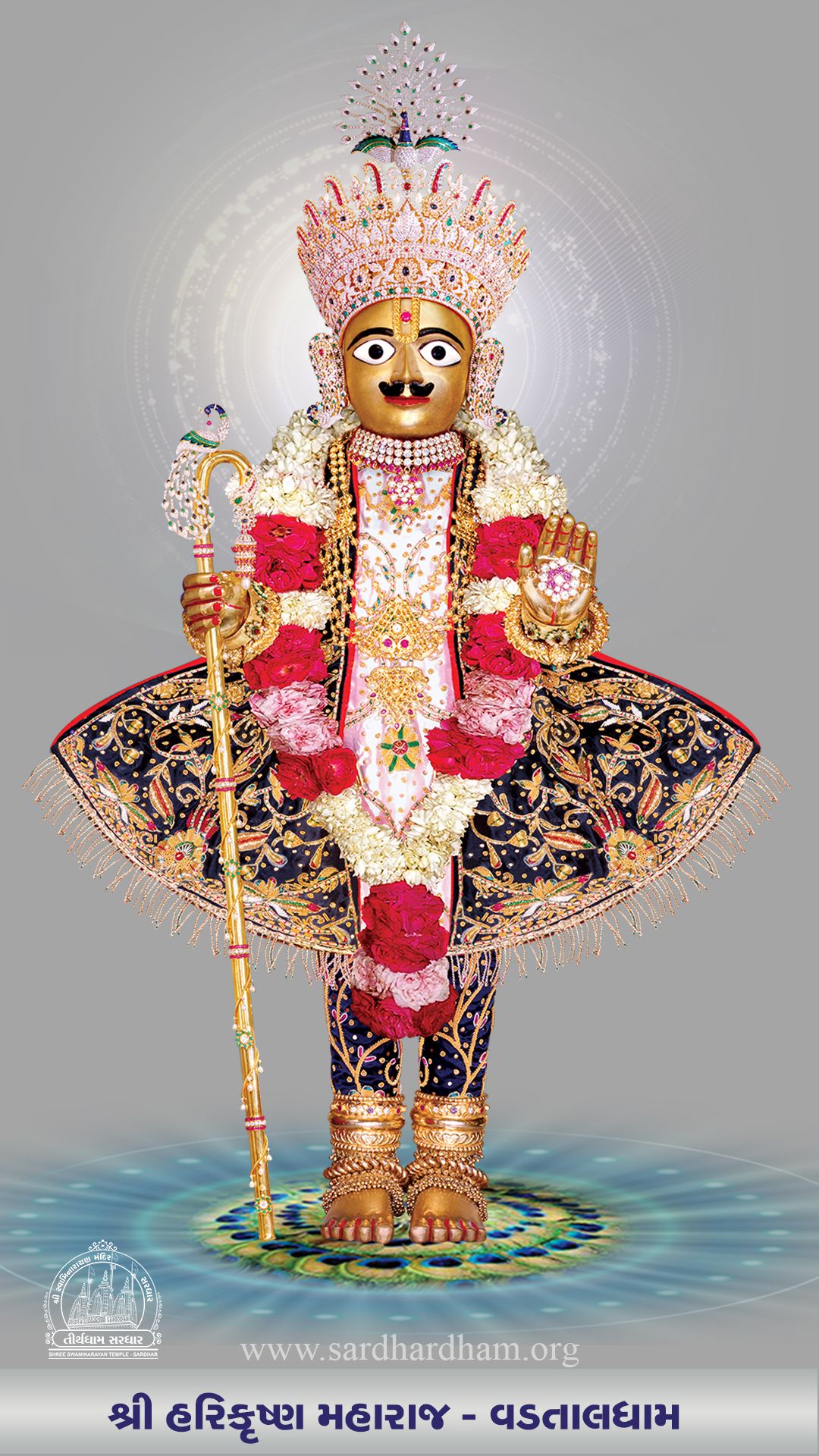 Golden Swaminarayan statue with floral garland